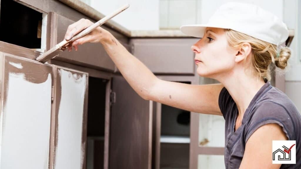 Woman repainting kitchen cabinets