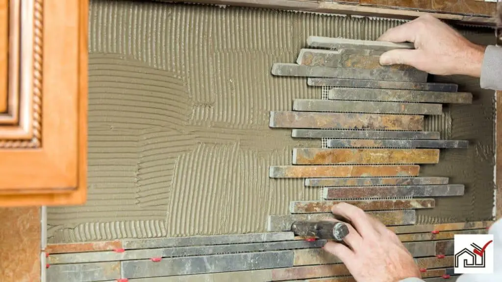 Man installing backsplash